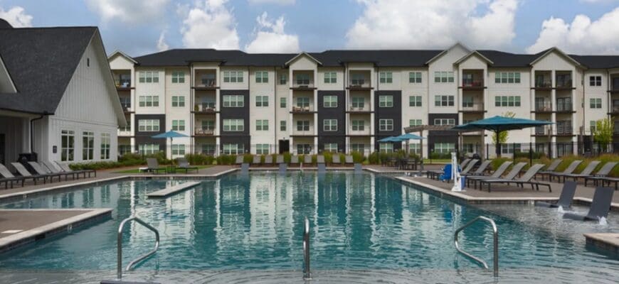 Exterior pool photo that shows some of the property building at Gateway Village